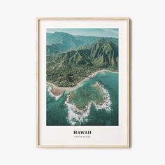 an aerial view of the hawaiian coast with mountains and ocean in the background, framed in wood