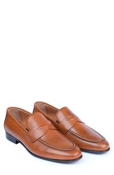 Handmade of smooth leather, this moc-toe dress shoe with a classic penny loafer silhouette offers a sophisticated, elegant look. Leather upper and lining/synthetic sole Made in Turkey Classic Cognac Slip-on Moccasins, Formal Cognac Moccasins With Round Toe, Cognac Round Toe Loafers For Semi-formal Occasions, Semi-formal Cognac Loafers With Round Toe, Classic Cognac Leather Slip-on Shoes, Classic Cognac Moc Toe Loafers, Classic Cognac Moccasins With Round Toe, Classic Cognac Loafers For Formal Occasions, Cognac Round Toe Loafers For Business