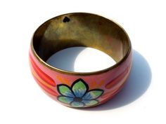 "Simply beautiful brass enamel bangle with an intricate hand-painted flower design with a clear acrylic coat. Great vintage look, a touch of tarnish and great character. Had a perched heart on the inside. Measures approximately 1.5\" wide and inside diameter is 2 5/8\". NOTE: The beauty of all ethnic jewelry comes to form its distinct rustic feel. There are unique variations in color and texture due to the handmade process." Hand Painted Bohemian Bangle Jewelry, Bohemian Hand-painted Bangle Jewelry, Bohemian Hand Painted Bangle Jewelry, Handmade Vintage Enamel Bangle, Vintage Handmade Enamel Bangle, Vintage Hand Painted Jewelry For Festival, Vintage Multicolor Enamel Bangle, Vintage Multicolor Festival Bangle, Aesthetic Account