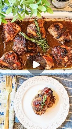 a pan filled with meat covered in sauce and garnished with herbs