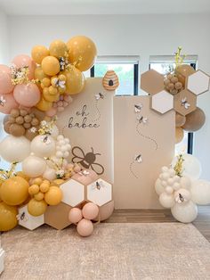 balloons and honeycombs are arranged on the wall in front of an open door