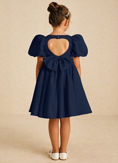 Muffin showcases a charming A-line shape in matte satin, featuring a stylish square neckline and a convenient zipper closure adorned with covered buttons. Finished with lovely bows, this dress is a delightful blend of elegance and whimsy for any young bridesmaid. Puff Sleeve Dress With Bow For Party, Fitted A-line Dress With Bow Straps, Elegant Dresses With Bow Tie Back For Dress-up, Elegant Dresses With Bow Tie Back, Elegant Puff Sleeve Dress For Dress-up, Elegant Puff Sleeve Dress For Dress-up Occasions, Chic Dress With Bow Detail, Fitted Solid Color Dress With Bow, Party Dress With Bow Tie Back And Square Neck