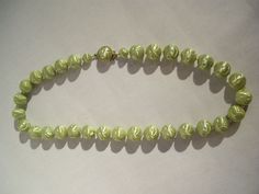 "This pretty mint green vintage necklace dates from the 50s. It is made of green lucite beads 5/8 \"(1.7 cm) in diameter in which there are festoons and small rounds. Each of these beads are spaced apart by tiny beads of clear, colorless glass. It is 23 \"(58.5 cm) long. The gold metal clasp is decorated with a half green pearl. This jewel is in excellent condition and is kept in a smoke and pet free environment." Tiny Beads, Green Pearls, Green Vintage, The 50s, Vintage Necklace, Mint Green, Favorite Jewelry, Necklace Etsy, Gold Metal