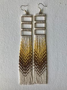 "Triple brass rectangle hand beaded earrings.  Ivory, brown, and soft yellow. Approximate 6\" length Modeled photo is to show size" Hand Beaded Earrings, Soft Yellow, Hand Beading, Model Photos, Vintage Brass, Beaded Earrings, Jewelry Earrings Dangle, Beading, Etsy Earrings