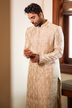 Pearl beige raw silk sherwani with all over hand embroidery, French knot detailing and mandarin collar. Paired with kurta and churidar.
Component: 3
Pattern: Hand Embroidered
Neckline: Mandarin Collar
Sleeve Type: Full Sleeves
Fabric: Raw Silk
Color: Beige
Other Details: 
Front concealed closure on sherwani
Occasion: Wedding,Destination Wedding - Aza Fashions Raw Silk Naqshi Bandhgala For Traditional Ceremonies, Raw Silk Bandhgala With Intricate Embroidery For Traditional Ceremonies, Raw Silk Straight Kurta Sherwani For Traditional Ceremonies, Ceremonial Raw Silk Sherwani With Naqshi, Raw Silk Sherwani For Traditional Ceremonies, Ceremonial Naqshi Sherwani In Raw Silk, Raw Silk Sherwani For Eid Ceremonies, Raw Silk Sherwani For Eid And Traditional Ceremonies, Elegant Resham Embroidery Nehru Jacket For Traditional Ceremonies