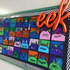 a colorful bulletin board with the word geek spelled in bright letters and monsters painted on it