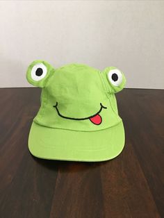 So Dorable Baby 0-6 M Frog Face Hat/Cap Green. Very cute. Nice preowned condition. Stretchy band in back. There is paper inside it in photos to show the face. Any questions please ask and thanks for looking! US bidders only Please!! Frog Bucket Hat, Frog Face, Boy Hat, Hat Cap, The Face, Band, Hats, Green