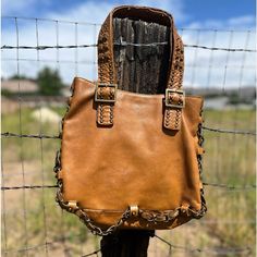 Gorgeous golden leather vintage Betsey Johnson shoulder bag with chain braid adornment. Signature vintage Betsey studded lips on the back of bag. Some wear on underside of straps. Some slight leather discoloration but in great vintage condition for its age.  Magnet closure Inner zipper pocket  Inner pouch pockets  14" x 10" About 5 1/2" deep 10" handle drop Smoke-free and golden retriever-friendly household. Chain Braid, Vintage Betsey Johnson, Denim Handbags, Bag With Chain, Betsey Johnson Bags, Vintage Velvet, Metallic Leather, Vintage Leather, Betsey Johnson