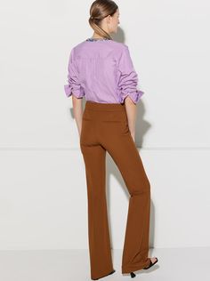 The Danae is the newest pant in the CÂLLAS pant collection. It is a high rise pant with the waistband sitting at the true waist position. It fits slim thru the hips and thighs, and from below the knees, gently flares to the hem. Based on the popular CÂLLAS Jules pant, the Danae has a long and lean flare leg silhouette tailored in a fluid crepe stretch fabric with 4-way stretch. Style, comfort, and versatility come together to create a wardrobe staple. The unique weave of the fabric makes it prac Stretch High-waisted Rayon Pants, Sleek Full-length Pants With 4-way Stretch, Black High-cut Leg Elastane Pants, Non-stretch Flared Hem Pants, Black Tapered Leg Pants With 4-way Stretch, Perfect Pant, High Rise Pants, Stretch Crepe, New Pant