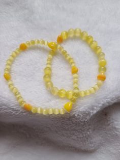 Lovely sunny yellow beads in 2 sizes with small yellow heart shaped beads. Small wrist. Size is approximate  Can be made in other colours Adjustable Yellow Jewelry With Heart Beads, Adjustable Hypoallergenic Yellow Beaded Bracelet, Yellow Beaded Bracelets With Heart Beads For Gifts, Yellow Beaded Stretch Bracelet With Round Beads, Casual Yellow Beaded Bracelets With 8mm Beads, Yellow Beaded Stretch Bracelet, Casual Yellow Beaded Bracelet With 8mm Beads, Yellow Beaded Bracelets As Gift, Yellow Hand-strung Beaded Bracelets For Gifts