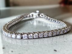 AMAZING Vintage 14k White Gold 8 CTW Diamond Tennis Bracelet! * Crafted beautifully in 14k white gold with fifty four (54) - approximately .15CT bright and clear round cut sparkling diamonds!! * Approximately 8 CTW  * G/H color VS/SI1 clarity! * Bracelet is approximately 7.25" long and 3.75mm wide. * Weighs 14 Grams of solid 14k white gold! * Clean and sparkling!! Shipped FAST AND FREE, in gift box and fully insured Diamond White Platinum Diamond Bracelet For Anniversary, Silver Moissanite Diamond Bracelet With Brilliant Cut, White Gold Diamond Bracelet With Prong Setting, Diamond White Sterling Silver Bracelet With Brilliant Cut Diamonds, Silver Tennis Bracelet With Prong-set Diamonds, Silver Moissanite Tennis Bracelet With Brilliant Cut, Dazzling Diamond Bracelet With Accents For Anniversary, Diamond White Round Cut Diamond Bracelet For Anniversary, Diamond White Round Cut Bracelet For Anniversary