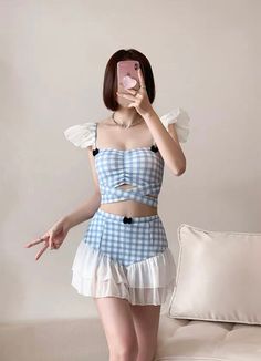 Cute Blue Gingham Ruffle Two Piece Kawaii Swimsuit with Skirt Whether you're in for tankini summer or just looking for a bit more coverage at the beach, we got you covered!(pun uninteded) Introducing our new obsession - this Japanese style two piece kawaii bathing suit. Looking for a cute swimsuit with skirt? We've got just that for you. Made with an adorable blue gingham fabric, this kawaii swimsuit features white ruffles that transform the high waisted bottoms into a skirt. Little black bows tie in the coquette influences. SIZE INFO Please choose according to your bra cup size. S - 70ABC/32ABC - 75AB/34AB M - 75BC/34BC - 80AB/36AB L - 80BC/36BC - 85AB/38AB *Standard shipping time to the US is 9-19 business days. Please consult our shipping page for shipping time estimates for other count Cute Ruffled Swimwear For Vacation, Cute Fitted Ruffle Swimwear, Cute Fitted Ruffled Swimwear, Summer Ruffled Swim Skirt For Poolside, Summer Poolside Swim Skirt With Ruffles, Cute Spring Beach Tankini, Cute Sleeveless Spring Tankini, Playful Ruffle Tankini For Vacation, Cute Summer Tankini For Poolside