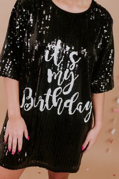 Party like it's your birthday! The It's My Birthday Sequin Dress features a round neckline, a stunning sequin design, a full lining, and the text " It's My Birthday" across the front in white. The ideal dress to accessorize and wear out on your big day! Short sleeves Round Neckline Above the knee hemline Sequin Pattern both front and back Full lining - not itchy at all Fit: oversized Fabric: 65% Polyester, 30% Cotton, 5% Spandex Imported Model Specs: Emily is wearing a size small in the photo.Ho Birthday Sequin Dress, Sequin Dress Black, Sequin Pattern, Birthday Girl Outfit, It's My Birthday, Sequin Design, Vip Group, Everyday Chic, Black Sequin Dress