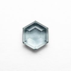 the face of an aqua blue diamond on a white surface