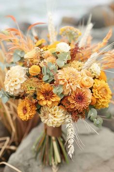 a bouquet of flowers sitting on top of a rock