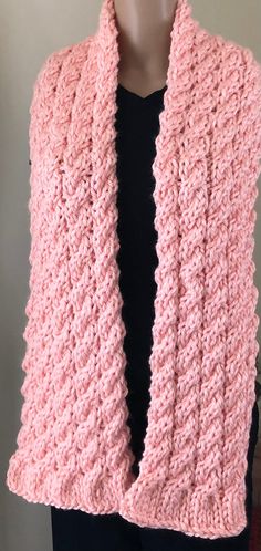 a woman wearing a pink knitted scarf