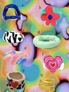 several different types of rings and bracelets on a multicolored background with hearts