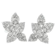 Similar to the iconic Harry Winston cluster design, these earrings are crafted with marquise and round shape diamonds set to create the illusion of a larger pear shape diamonds. There are an estimated 4 carats total weight of bright white eye clean diamonds. The diamonds are G/H color, VS-SI clarity. When looking closely at the studs you will see a beautiful arrangement of mixed shape diamonds creating a large pear shape look. The earrings measure 7/8 inches in length and 3/4 inch in width Harry Winston Earrings, Modern Hoop Earrings, Diamond Chandelier Earrings, Diamond Cluster Earrings, Flower Cluster, Floral Studs, Harry Winston, Gold Statement Earrings, Gold Diamond Earrings