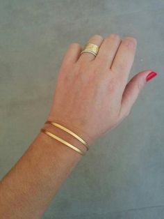 Choose this Bracelet as a bridesmaids gift ! It is simple and lightGolden 2 Strips Cuff Bracelet, available in gold/silver platingMade of 24k gold plated brass base, matte finished.Dimensions: Diameter:    2.5 inch         6 cm Width:          0.3 inch         1 cmBracelet Total length 7.25inch / 18.5cmFits wrist measurement 6.3inch/16cm to 7.1inch/18cmItem will be shipped in a branded gift box.Designed by HilaAssaJewelry.This bracelet is also available in silver plating:https://www.etsy.com/lis Elegant Adjustable Band Cuff Bracelet, Elegant Cuff Wedding Jewelry, Elegant Cuff Jewelry For Weddings, Dainty Adjustable Bangle For Anniversary, Gold Bangle Cuff Bracelet For Wedding, Elegant Rose Gold Band Jewelry, Elegant Handmade Wedding Bangle, Dainty Bangle Cuff Bracelet For Anniversary, Dainty Anniversary Cuff Bracelet Bangle