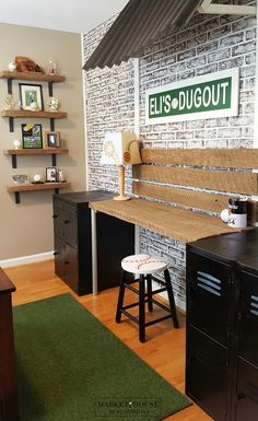 a room with a brick wall and wooden flooring has a green rug on the floor