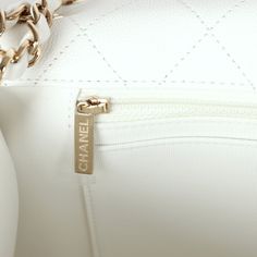 This XXL flap bag is in white shiny caviar with light gold tone hardware and has a front flap with signature CC turnlock closure, rear slip pocket and interwoven white leather and light gold tone chain link shoulder straps.The interior is lined in white canvas and features a zipper pocket with Chanel pull and an open pocket below.Collection: 24COrigin: ItalyCondition: New and never wornAccompanied by: Chanel box, Chanel dustbag, carebook, felt and retail UPCMeasurements: 16" width x 11" depth x Chanel Box, Shopping Chanel, Hermes Bags, Carry All Bag, White Canvas, Flap Bag, Prada Bag, White Bag, White Leather