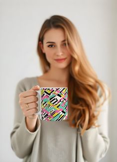 a beautiful young woman holding a coffee mug