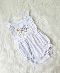 This listing is for a white sunsuit with animals and name. This is such a sweet outfit! I can change thread colors. If you want different colors used message me. White Summer Bubble Romper For Playtime, White Bubble Romper For Summer Playdate, White Bubble Romper For Playdate In Summer, Fun Fitted Cotton Bubble Romper, Playful White Jumpsuits And Rompers With Ruffles, Playful White Jumpsuit With Ruffles, White Bubble Romper For Playwear In Fun Style, White Fun Bubble Romper For Playwear, White Fun Style Bubble Romper For Playwear