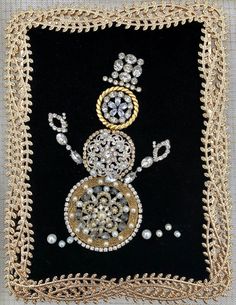 a black and gold beaded square with an image of a snowman