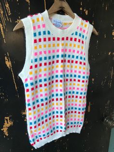 "Fantastic vintage 60's/70's mod colorful square pattern knit sleeveless sweater top. Longer fit, but can be tucked in nicely. 100% acrylic. In good vintage condition. Made by RJ Pumpkin. Will best fit medium. Measurements laying flat: fabric stretches Armpit to armpit: 18\" Length: 25\"" Multicolor Fitted Retro Tank Top, Fitted Multicolor Sweater Vest For Fall, Retro Multicolor Sleeveless Vest, Retro Multicolor Summer Vest, Multicolor Retro Summer Vest, Multicolor Sleeveless Vest For Fall, White Fitted Retro Sweater Vest, Multicolor Sleeveless Sweater Vest For Fall, Vintage Multicolor Sleeveless Sweater Vest