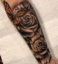 a black and white rose with a butterfly on it's arm, next to a tattoo