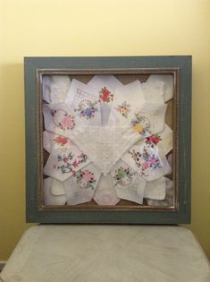 an old frame is covered with handkerchiefs and other decorative items in the shape of a heart