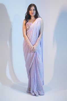 Lilac saree featuring embroidered abstract motifs highlighted by sequin embellishments. Comes with matching padded sequined blouse.
Components: 2
Pattern: Embroidered
Type Of Work: Thread,Sequin,Crystal
Neckline: V-neck
Sleeve Type: Sleeveless
Fabric: Georgette Embroidery
Color: Purple
Other Details: 
Attached lining
Weight: 1.5 kgs
 Length: Blouse: 14.5 inches
Model Height: 5 ft 9 inches, wearing size M
Note: Gloves worn by the model are not for sale
Occasion: Sangeet,Reception - Aza Fashions Saree With Gloves, Saree Gloves, Lilac Saree, Indian Fits, Embellished Saree, Sequined Blouse, Abstract Motifs, Simple Saree Designs, Purple Saree