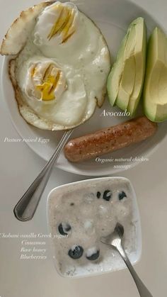 the breakfast is prepared and ready to be eaten with eggs, sausage, avocado, and yogurt