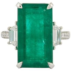 A Fabulous and Unique Green Emerald Ring!! 10.45 carat green emerald cut in a stunning elongated rectangular shape. 1.06 carats of round and special cut side diamonds all set in platinum. The ring is currently a size 6 but can easily be sized to any finger size. Antique Cocktail Ring, Green Emerald Ring, Emerald Diamond Ring, Detailed Jewelry, Mid Century Jewelry, Bypass Ring, Colombian Emeralds, Emerald Jewelry, Platinum Ring