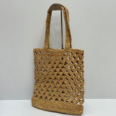 Embrace effortless summer style with this woven raffia tote bag, inspired by the iconic Prada design. Its open-weave construction and natural tan hue evoke a sense of carefree elegance, perfect for sunny days and beachside adventures. The spacious interior provides ample room for your essentials, while the "PRADA MILANO" inspired logo adds a touch of high-fashion appeal. Natural Color Crochet Bag With Woven Leather, Natural Colored Crochet Bag With Woven Leather, Beige Crochet Bag With Intrecciato Weave For Beach, Casual Bucket Straw Bag With Intrecciato Weave, Vacation Shoulder Bag With Intrecciato Weave And Double Handle, Intrecciato Weave Crochet Shoulder Bag For Vacation, Vacation Beige Shoulder Bag With Intrecciato Weave, Beige Intrecciato Weave Crochet Beach Bag, Chic Crochet Bag With Intrecciato Weave In Natural