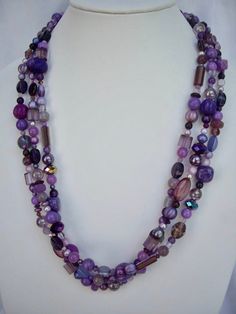 * Unique handmade purple triple strand necklace with various sizes and shapes of beads, including glass, crystals, gemstones and ceramic beads * This fabulous versatile necklace is 26 1/4 inches long including the silver tone hook and eye clasp Purple Czech Glass Beaded Necklaces, Purple Czech Glass Necklaces With Colorful Beads, Purple Czech Glass Beads For Jewelry Making, Purple Czech Glass Necklace With Colorful Beads, Purple Multi-strand Bohemian Beads, Handmade Purple Multi-strand Beads, Bohemian Multi-strand Purple Beads, Purple Bohemian Multi-strand Beads, Bohemian Purple Multi-strand Beads