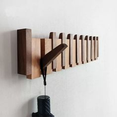 a wall mounted wooden object on the side of a wall