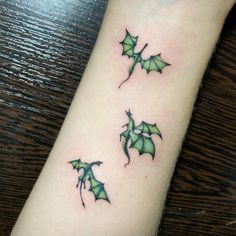 three green bats tattoo on the wrist