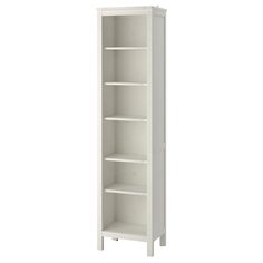 a tall white bookcase with three shelves