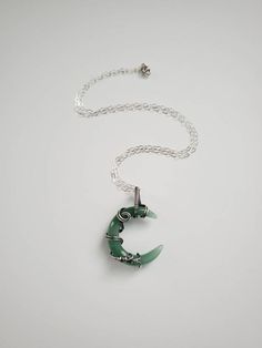 "This beautiful crescent moon shaped Green Aventurine stone is wrapped inside Sterling silver wire. Liver of sulphur has been used to give the silver an antique look, and it's sealed with Renaissance Wax to avoid tarnishing. The necklace has been made at 18\" on a Sterling silver chain, but length can be adjusted to fit your personal taste. The pendant hangs 1.5\" from chain. Finished with a lobster clasp. All my jewelry is handmade, and made with patience, care and love. In the unlikely event t Green Crescent Moon Charm Jewelry, Handmade Silver Jade Crystal Necklaces, Handmade Silver Jade Crystal Necklace, Wire Wrapped Crescent Metal Jewelry, Spiritual Crescent Wire Wrapped Necklaces, Handmade Silver Crescent Crystal Necklace, Handmade Green Crescent Jewelry, Green Aventurine Jewelry, Black Obsidian Ring