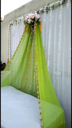 the bed is decorated with flowers and greenery for an outdoor wedding ceremony or special occasion