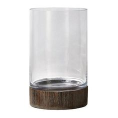 a clear glass with wooden base on a white background