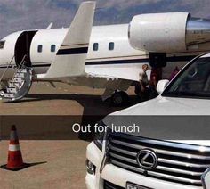 a white car parked next to an airplane