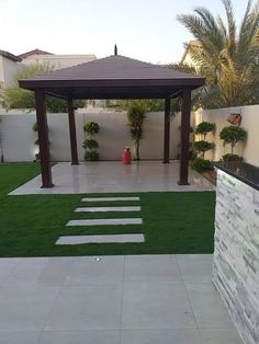 an outdoor patio with grass and stepping stones