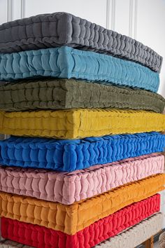 a stack of folded towels sitting on top of each other