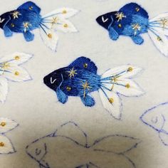 a close up of a blue and white flowered design on a fabric with gold stars