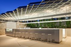 an outdoor bar with several stools in front of it