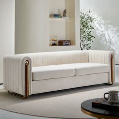 a white couch sitting on top of a rug in a living room