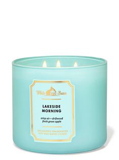 a blue candle that is sitting in front of a white background with the words lakeside morning on