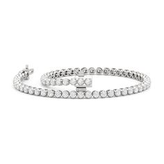 Designed with a clean and pared-down line of diamonds, this modern tennis bracelet will fit a minimalist's jewelry collection. The bracelet features a strand of polished precious metal "nuggets" topped with a round diamond. Compared to the usual prong baskets, the "nuggets" that secure each diamond in this bracelet feature a more solid base and a U-shaped recess where the precious gem can safely sit. Modern Tennis Bracelet For Formal Occasions, Modern White Round Tennis Bracelet, Modern Diamond Tennis Bracelet For Formal Occasions, Modern Round Diamond Tennis Bracelet, Modern Round Tennis Bracelet With Prong Setting, Modern White Tennis Bracelet With Prong Setting, Modern Tennis Bracelet With Prong Setting For Wedding, Modern White Gold Tennis Bracelet For Anniversary, Modern Wedding Tennis Bracelet With Prong Setting